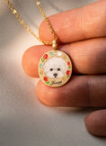 Load image into Gallery viewer, Close-up of a hand-painted dog portrait memorial necklace held in hand
