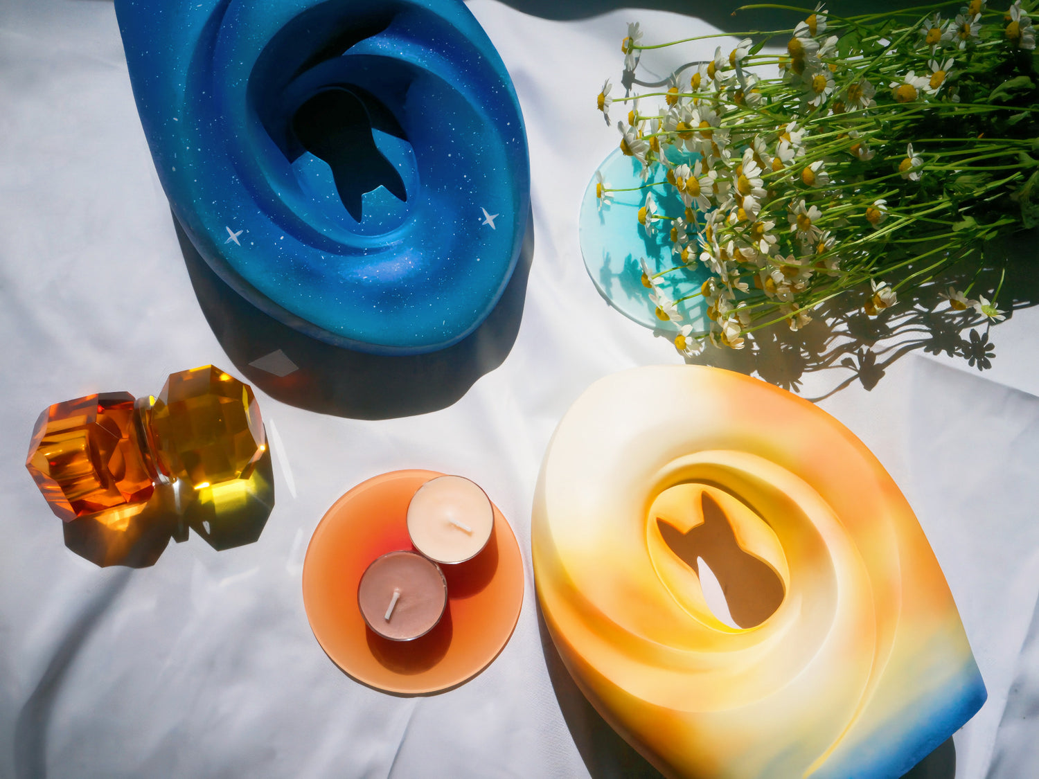 nfinite Stars and Sunset Memories Pet Urns in a peaceful, nature-inspired setting with candles and fresh flowers, symbolizing eternal love and a gentle transition.