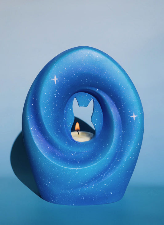 Infinite Stars Pet Urn with deep blue tones and a pet silhouette, symbolizing an everlasting bond under the night sky.