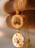 Load image into Gallery viewer, Two pet portrait memorial necklaces on display, showing custom hand-painted designs
