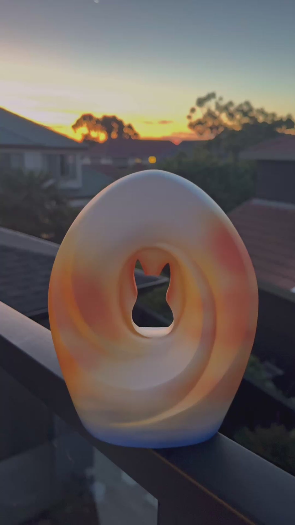 A sunset-colored pet urn, symbolizing hope and peace during remembrance.